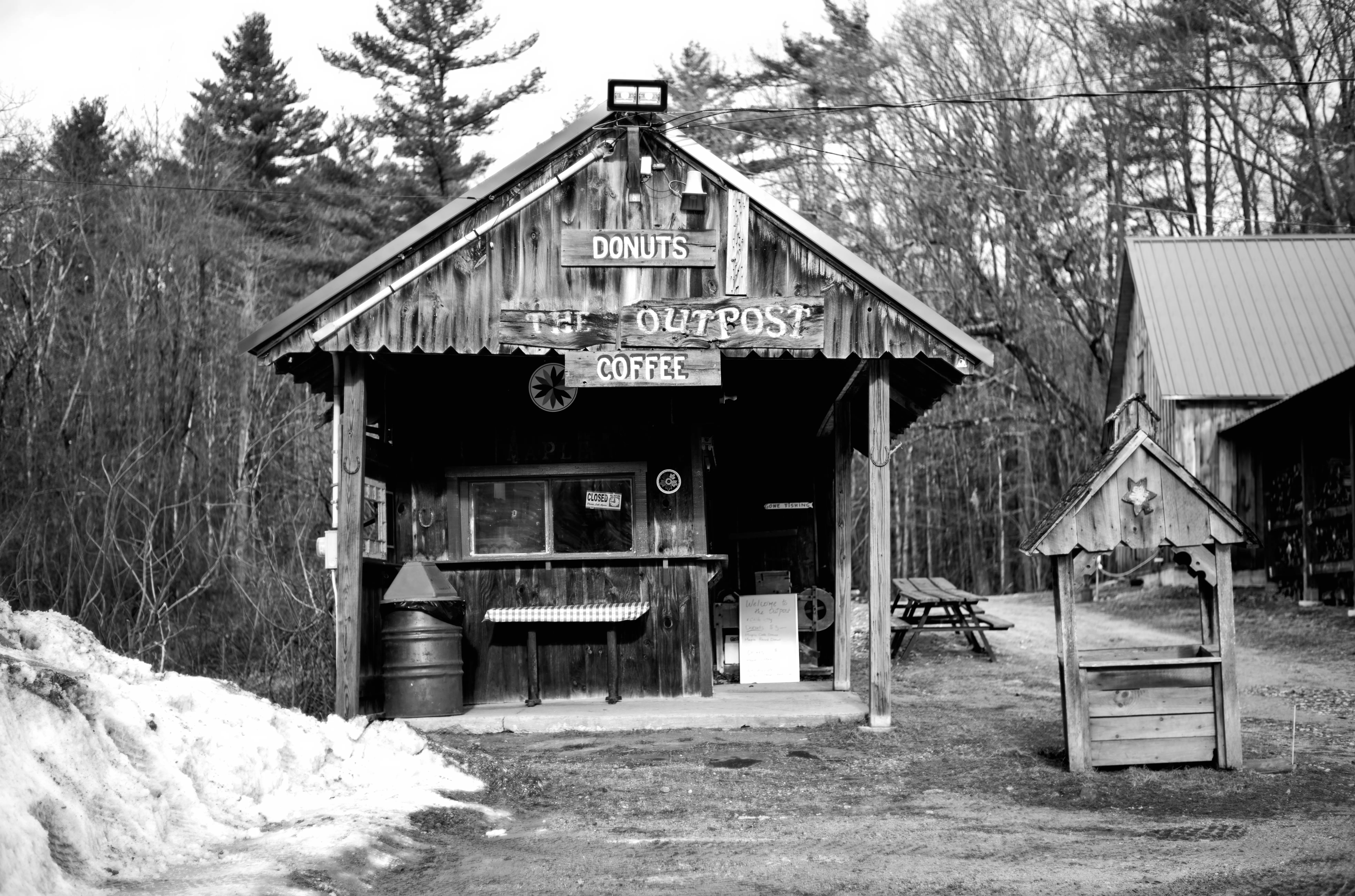 The Outpost coffee and donut shack, closed, snow banked on the left