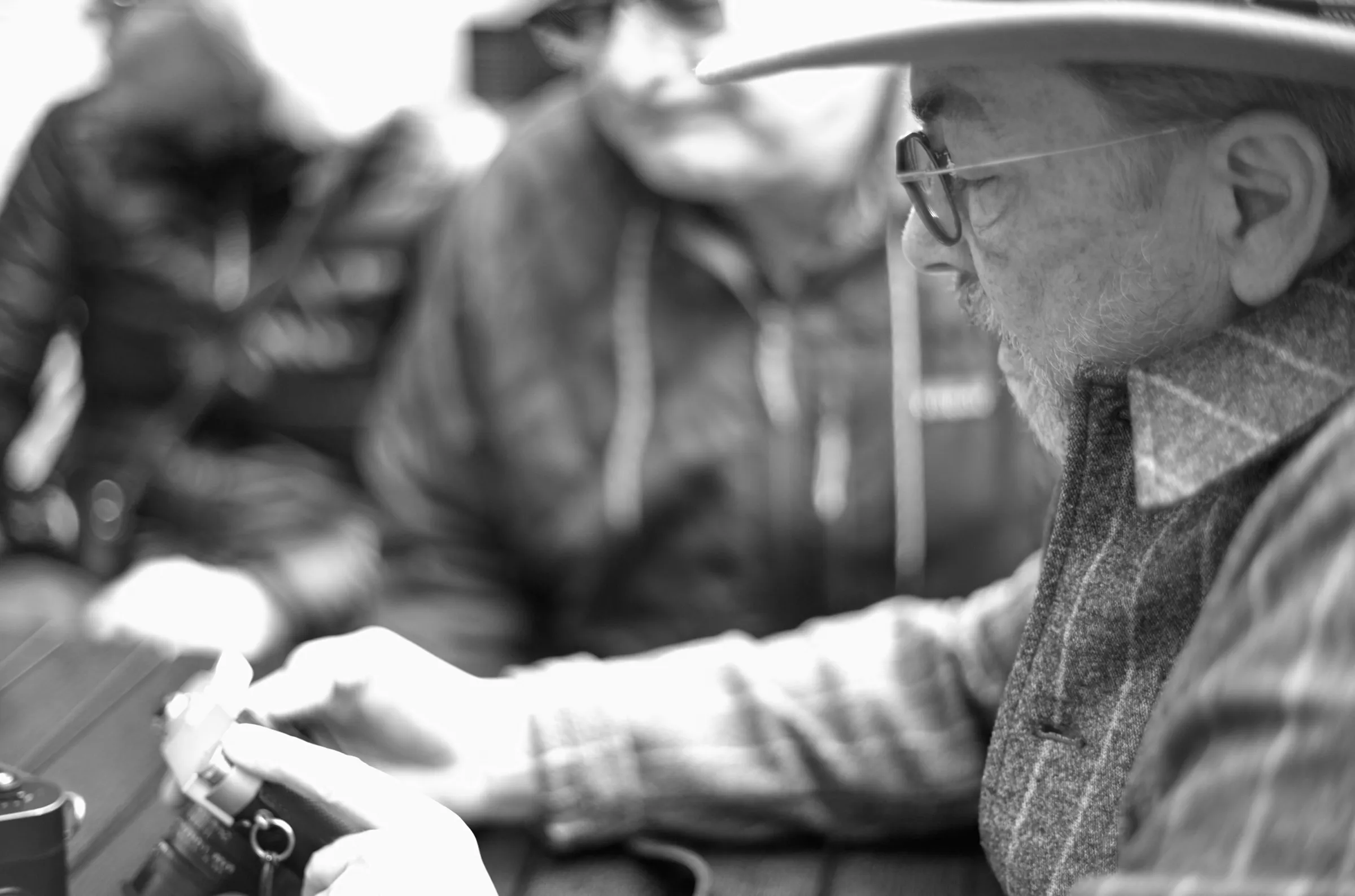 Thorsten Overgaard at the table at Elegy Coffee, adjusting a participant's camera before the morning walk