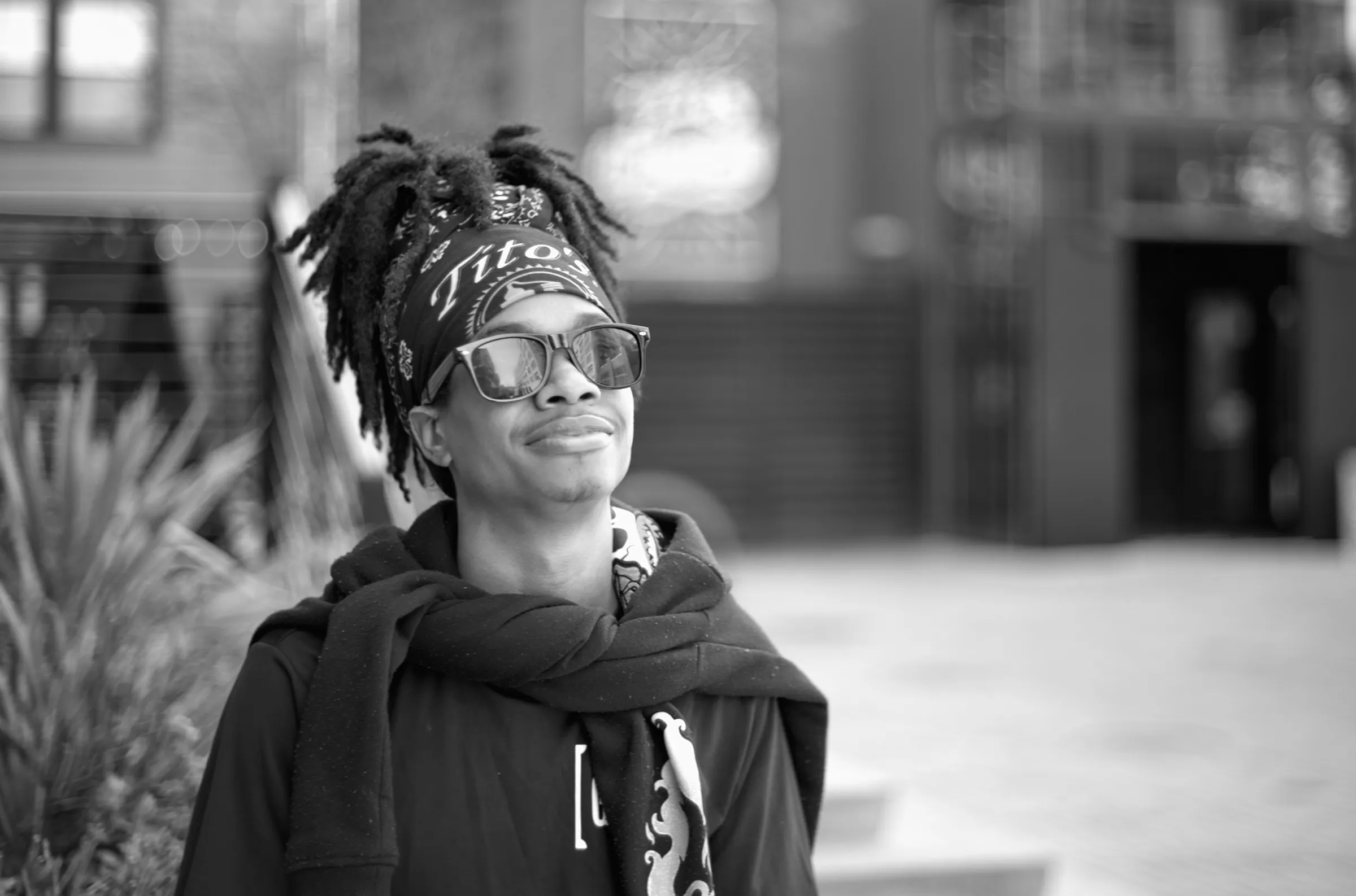 Young man with dreadlocks and mirrored sunglasses, looking upward, Germantown Nashville