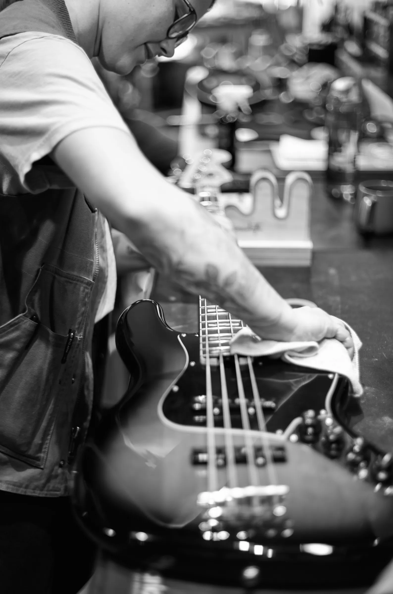 Guitar technician polishing the neck of a bass guitar, Carter Vintage Guitars